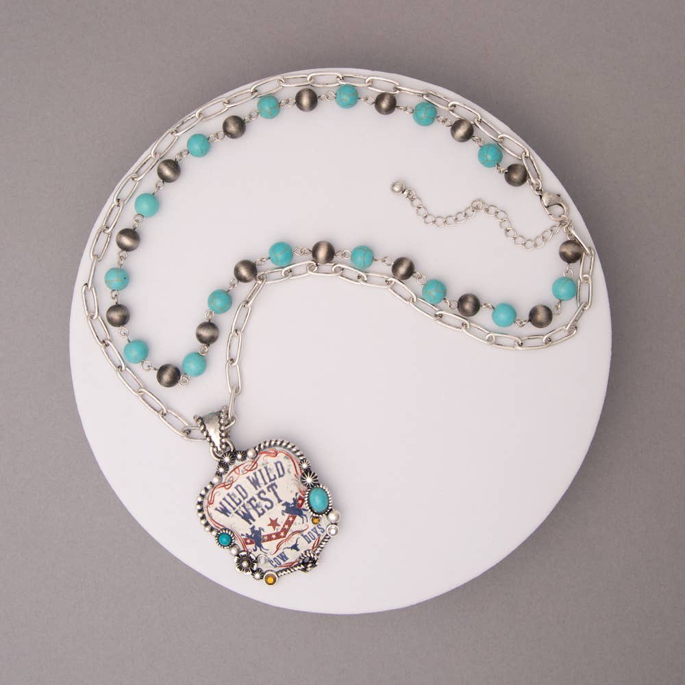 Necklace with turquoise and gray beads on a white plate against a gray background
