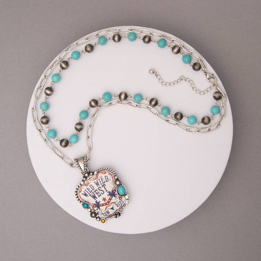 Necklace with turquoise and gray beads on a white plate against a gray background